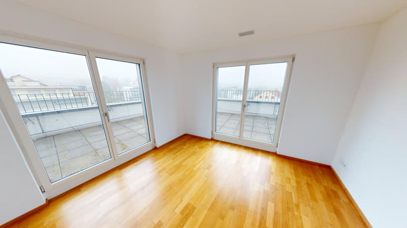 spacious room, hardwood floors, large sliding doors, balcony access, blank walls, power outlet