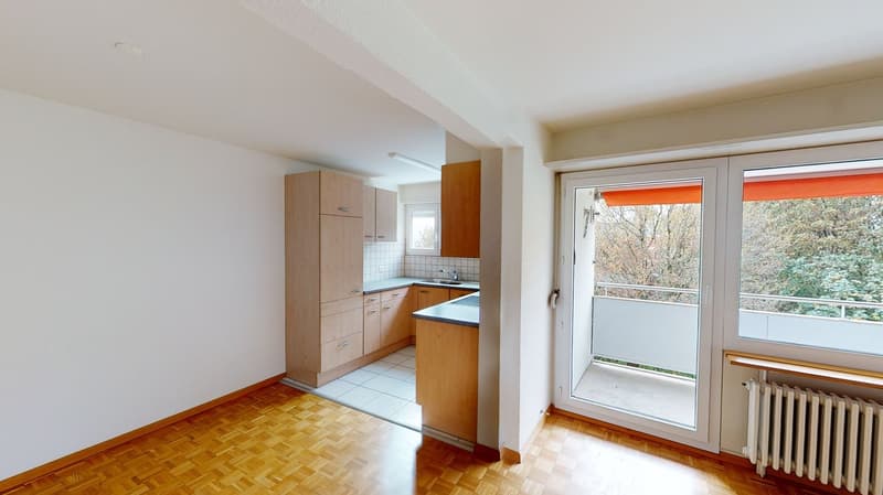 kitchen with wooden cabinets, white tiles, sink, faucet, balcony with railing, sliding glass door, radiator