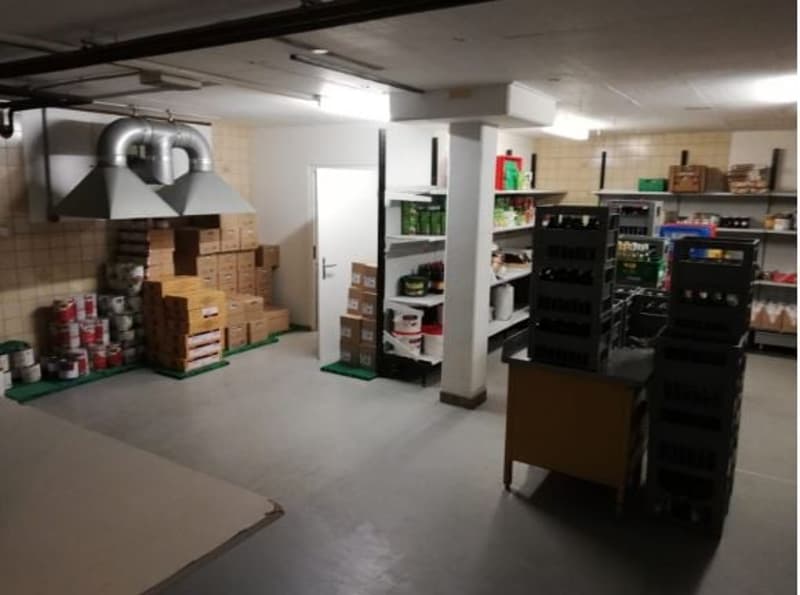 Large storage room or basement with shelves, boxes, and various household items. Appears to be used for storage and organization.