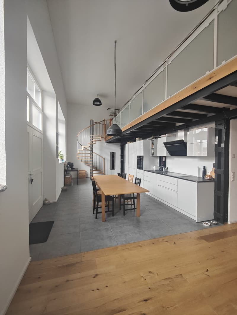 open space with dining area, kitchen, spiral staircase, balcony