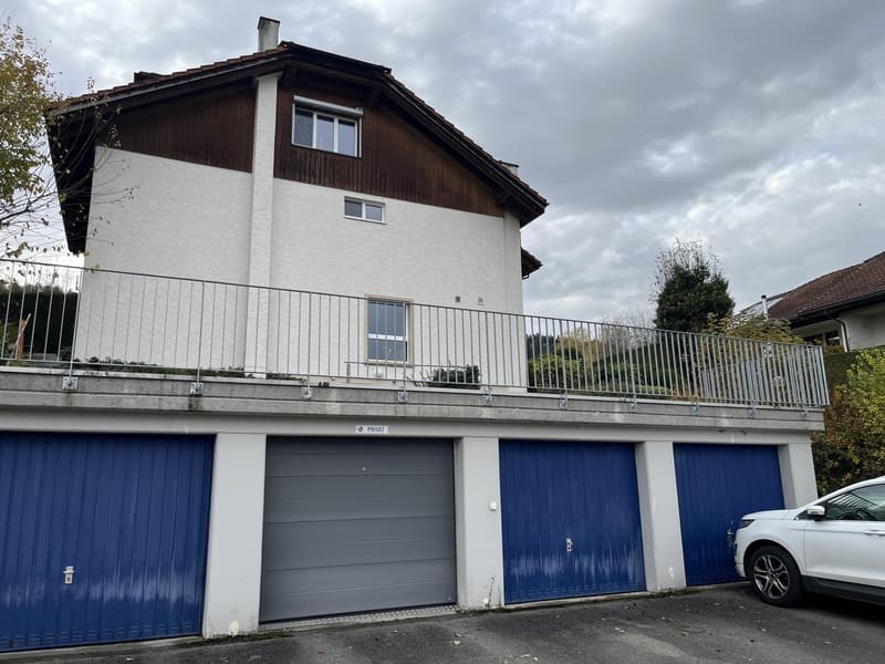 House: 2 story, red brick, white windows, garage, garden, car
