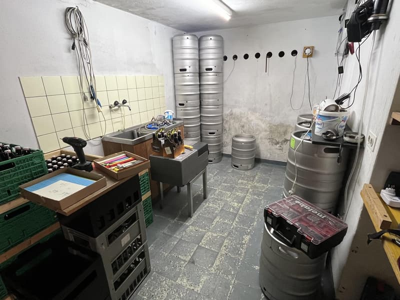 Utility room, tiled wall, kegs, workshop tools, buckets, electrical outlets