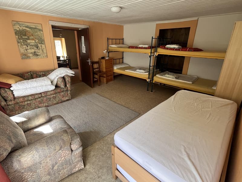 sleeping area, bunk beds, bed, couch, wooden chair, desk, cabinet, rug, picture frame, lamps