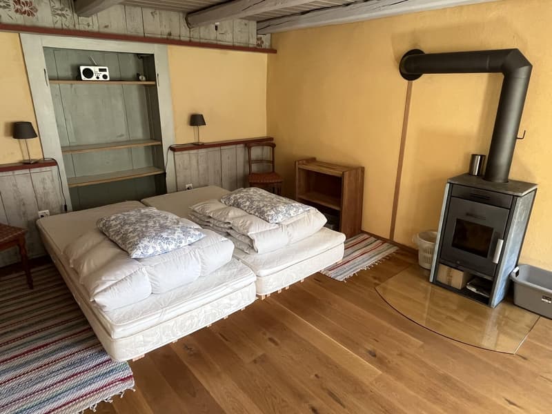 2 double beds, pillows, blankets, radio, fireplace, table, lamp, chair, cabinet