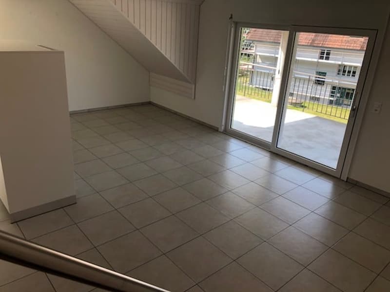 empty room, tiled floor, sliding glass door, white walls, metal railings on balcony