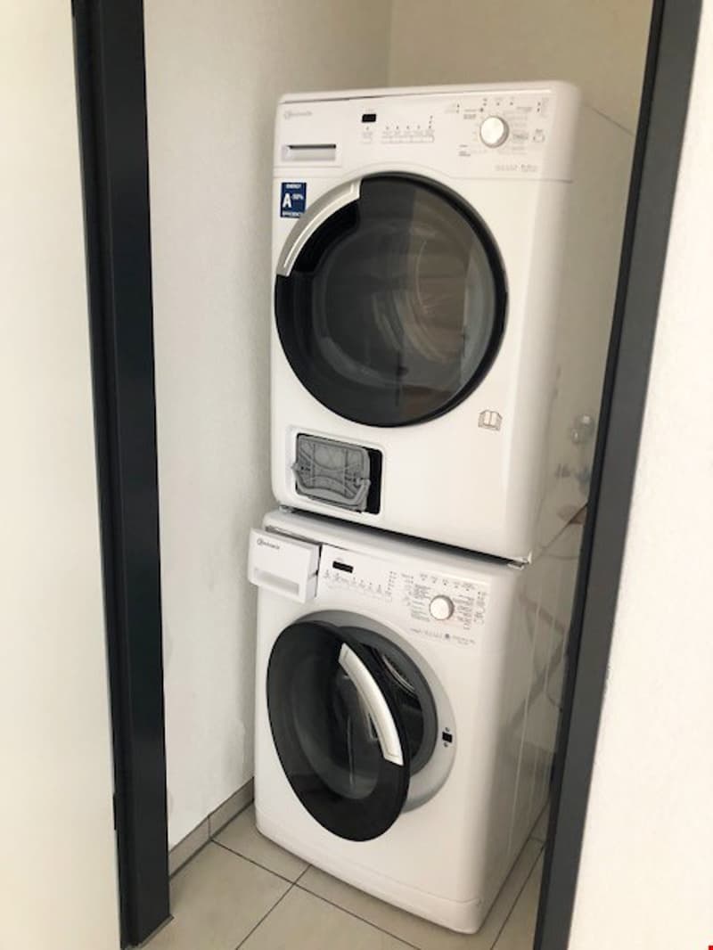 Stacked washing machine and dishwasher in a corner