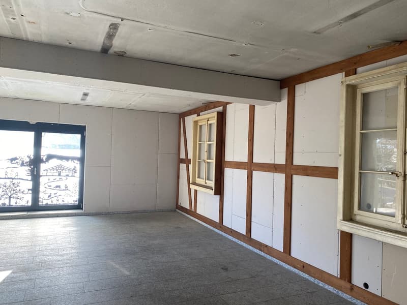 empty room, white walls, wooden beams, tiled floor, two windows