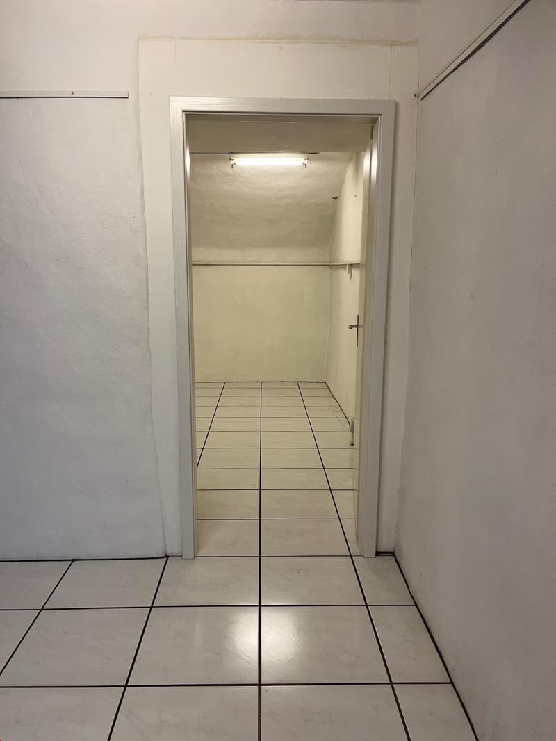 Open door, tiled floor, white walls, ceiling light