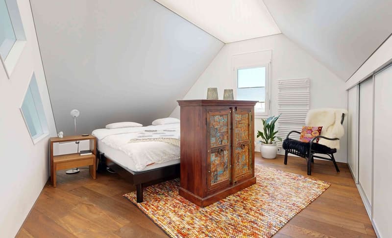 double bed, carpet, nightstand, wooden wardrobe, armchair, plant