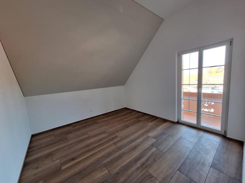 empty room, wooden floor, white walls, sliding glass door to balcony