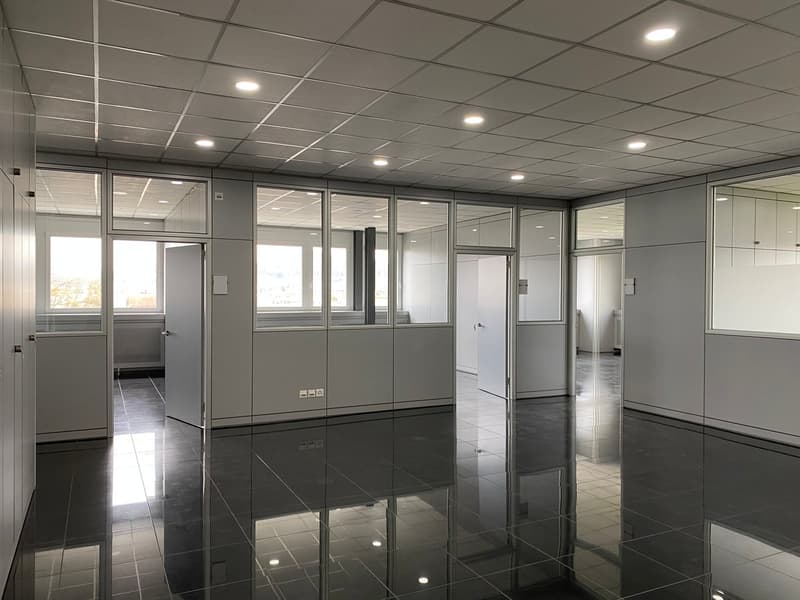 tiled floor, glass partitions, white walls, recessed lighting