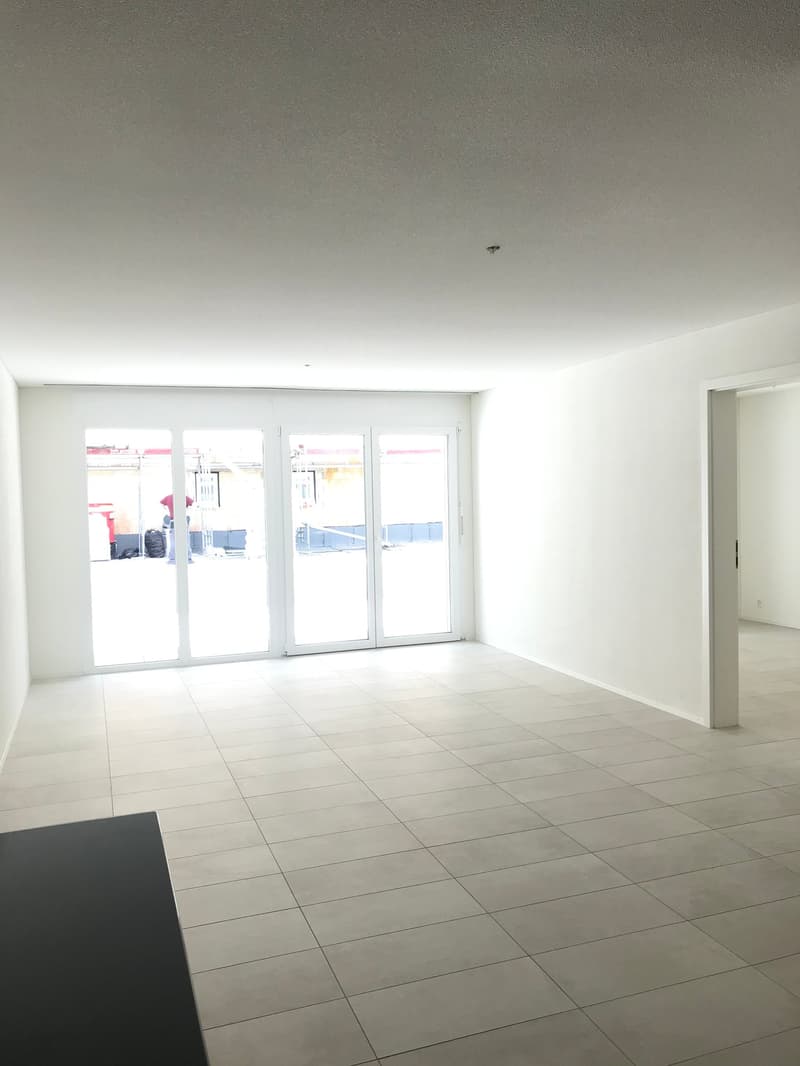 empty room, white walls, white tiles, sliding glass doors, balcony