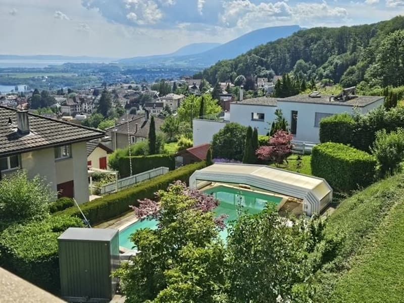 elevated house with pool and view of the town