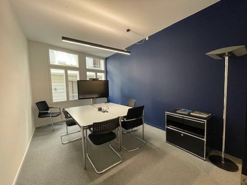 Conference room: table, chairs, monitor, lamp, cabinet, carpet