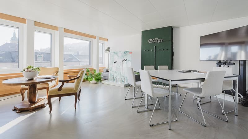 modern office room, large windows, light gray walls, white desk, white chairs, large flatscreen
