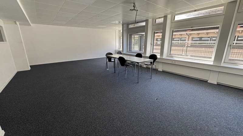 empty room, white walls, gray carpet, table and chairs, large windows
