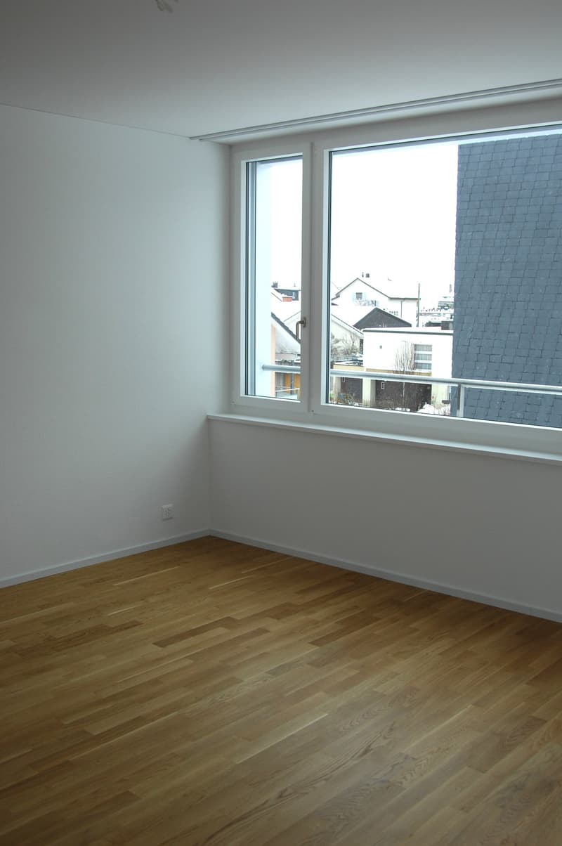 empty room, wooden floor, white walls, large window, power outlet