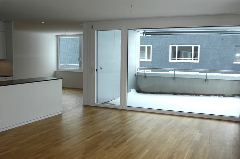 empty room, wooden floor, sliding glass doors, balcony, white walls, white cabinets