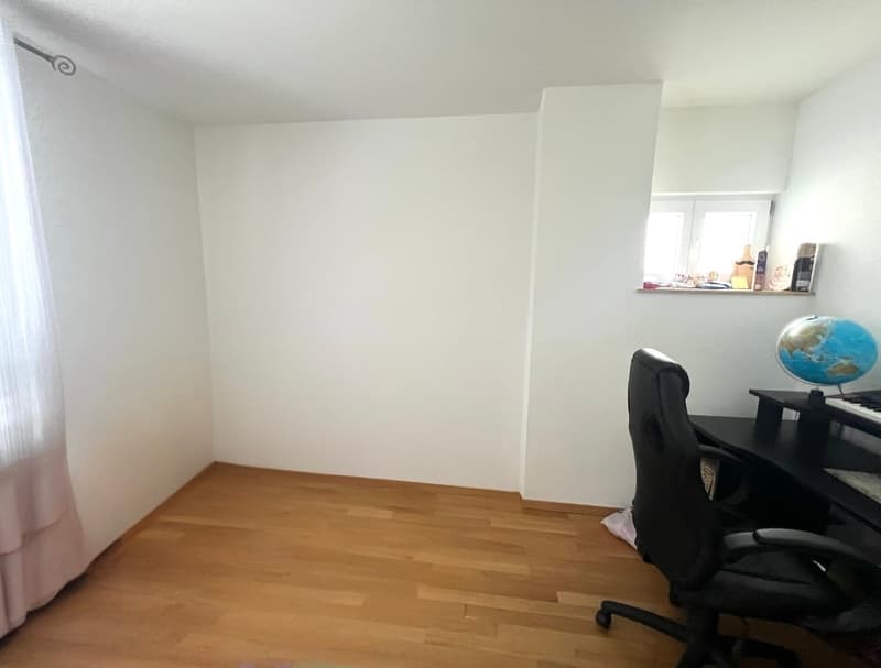 empty room, wooden floor, white walls, desk with chair, globe, window with sill