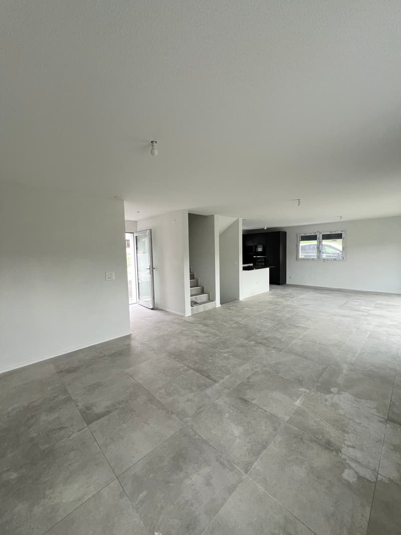 Empty room, white walls, gray tile flooring, glass door, staircase, window