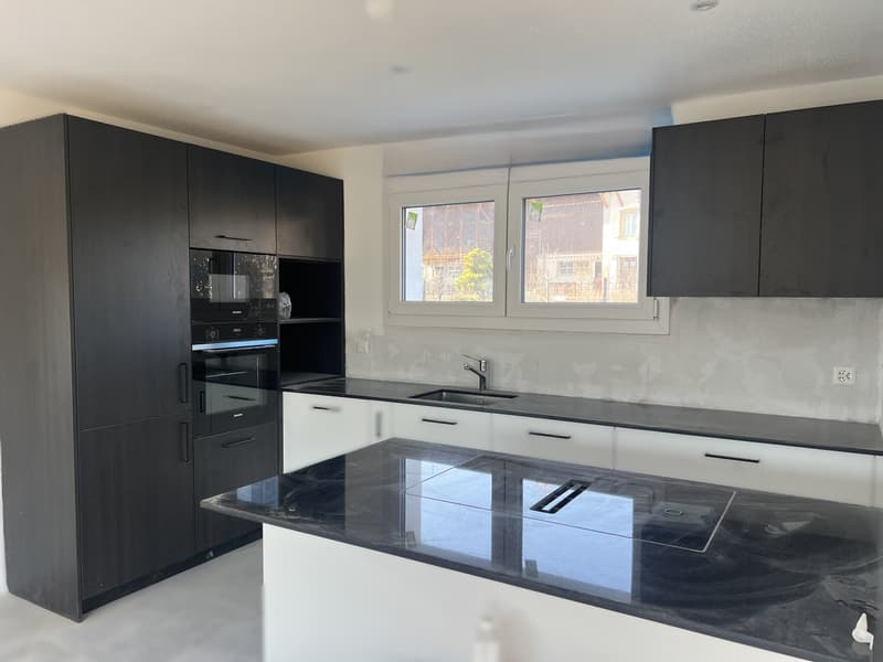 modern kitchen with black cabinets, white countertops, black granite countertop, built-in oven and microwave, sink with faucet, window
