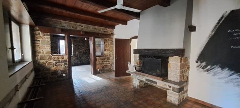Stone walls, wooden ceiling, fireplace, tiled floor, window, door