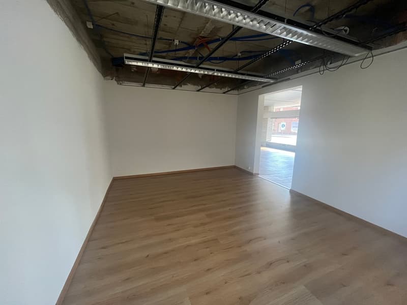 Empty room with wooden floor and white walls