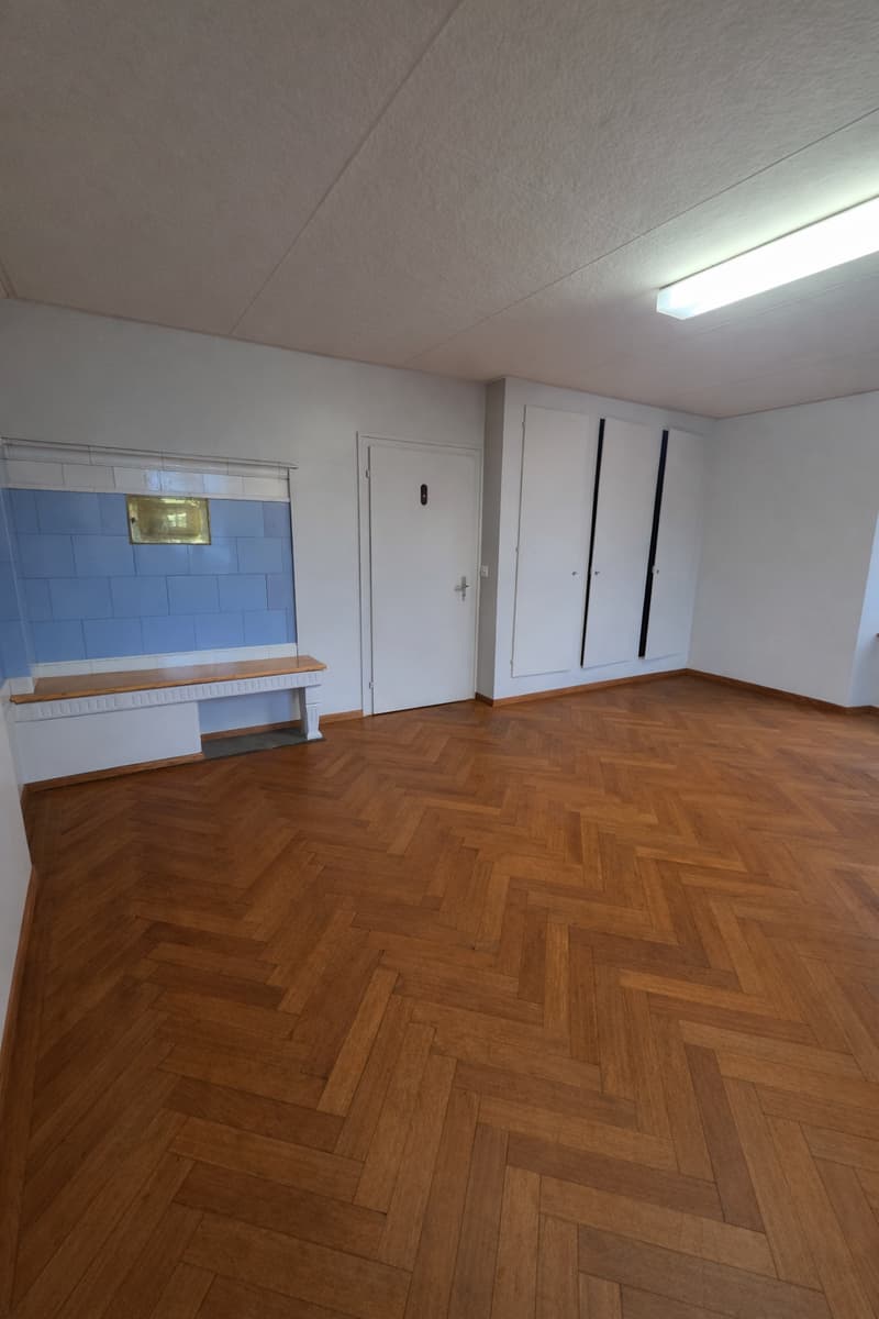 wooden parquet flooring, white walls, blue tiles, white closet, white bench, ceiling light