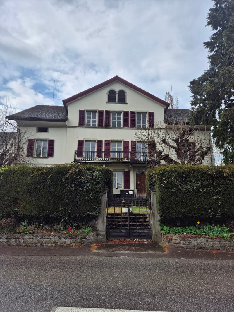 two story white house, black roof, red shutters, balcony