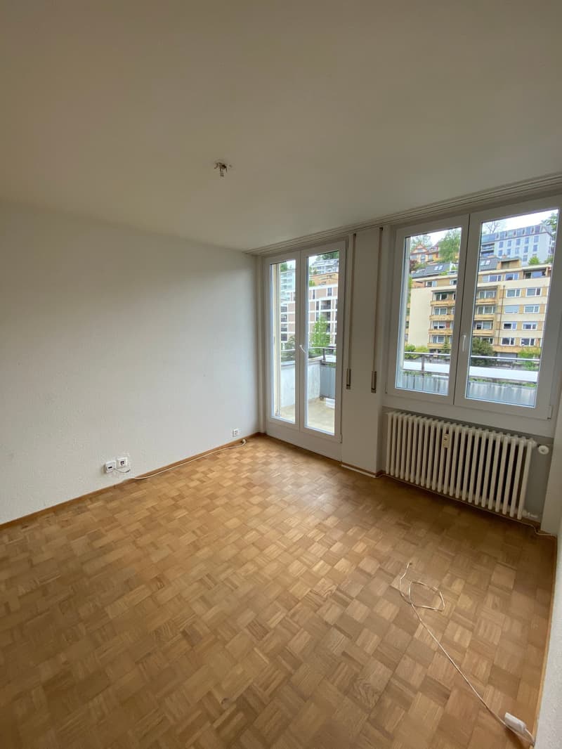 empty room, wooden floor, white walls, sliding glass doors, balcony, radiator, power outlets, balcony view