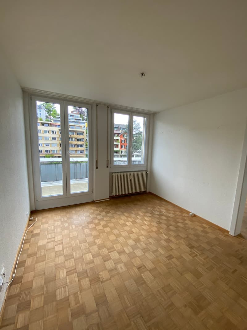 empty room, wooden floor, white walls, large windows, balcony, radiator