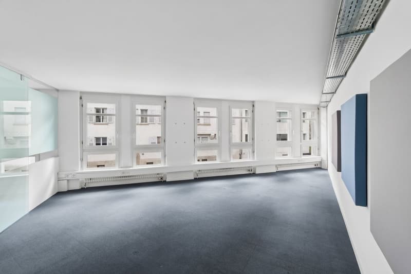 empty room, white walls, gray floor, large windows, glass door, radiators