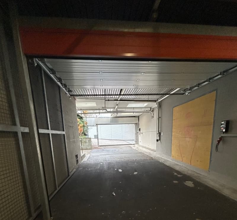 Garage entrance, paved floor, metal walls, concrete ceiling