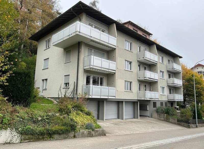 4 story apartment building, balconies, garages, driveway