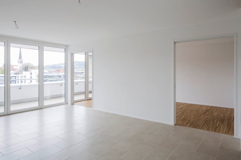 empty room, white walls, tiled floor, large windows, balcony