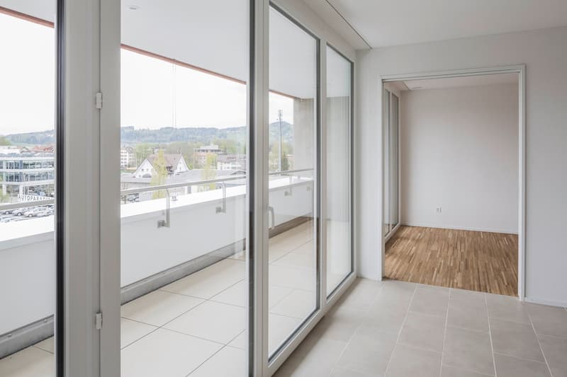 large sliding glass doors, balcony, tiled floor, white walls, open door