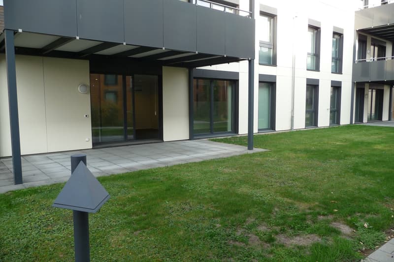 Apartment building, modern design, glass doors and windows, outdoor space, greenery