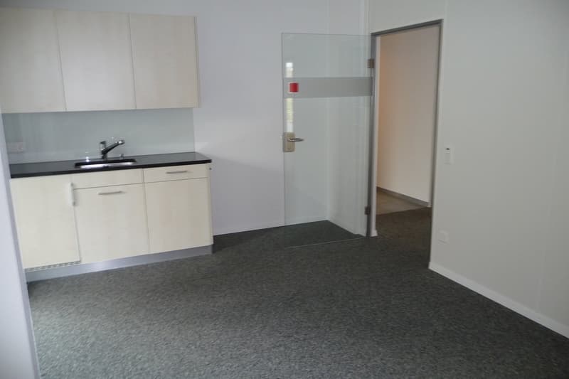 empty room, white cabinets, sink, faucet, glass door, open door