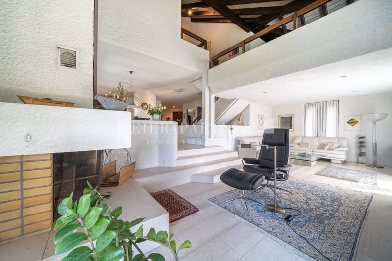 open concept, fireplace, staircase, sofa, two armchairs, rugs, couch, glass table, glass lamp, wooden ceiling