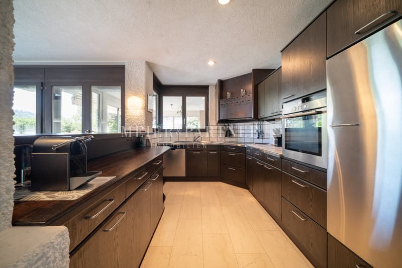 large modern kitchen, wooden cabinets, stainless steel appliances, wooden countertops, modern lighting, dishwasher, washing machine