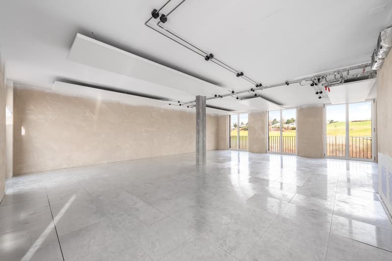 Empty room, tile flooring, large windows, metallic pillar, balcony