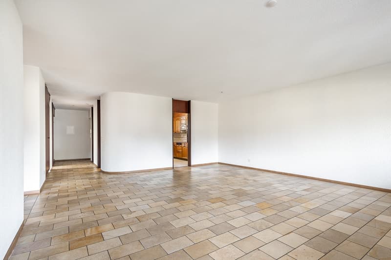 empty hallway with tiled floor and white walls