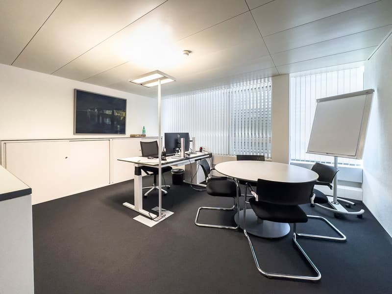 modern office room with white walls, two tables, chairs, desks, monitors, lamps, whiteboard