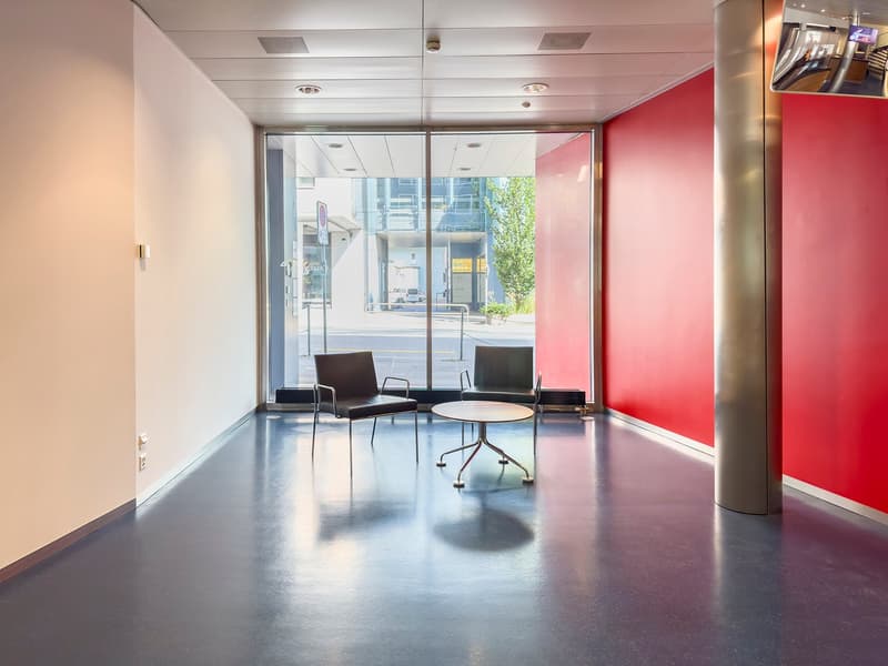 empty, modern style, sliding glass doors, two chairs, table, shiny red wall, metal pole, beige wall, ceiling with recessed lighting