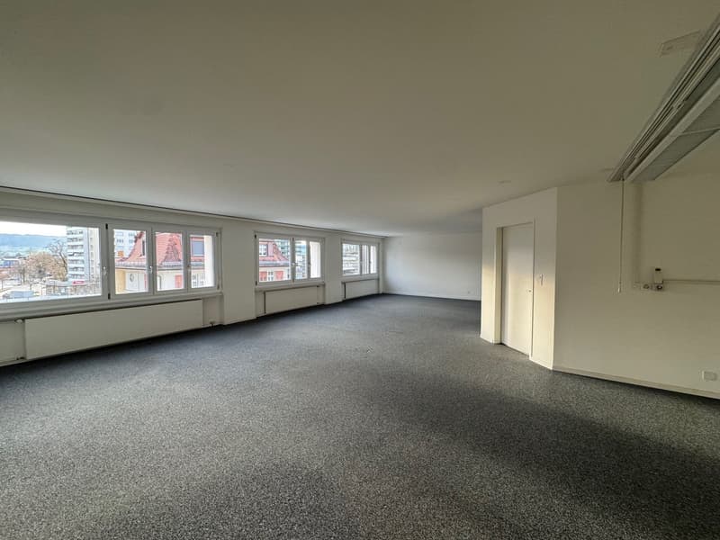 empty room, large windows, white walls, gray carpet, radiators