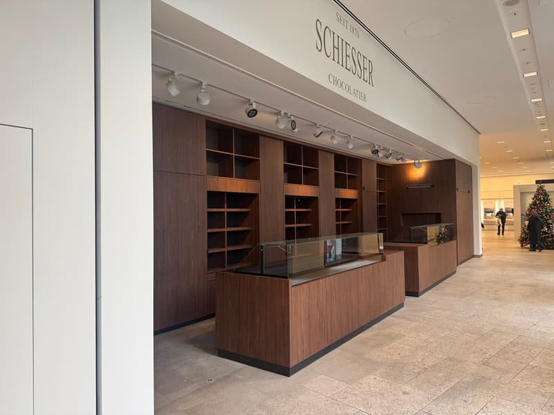 wooden shelves, glass display cases, tiled floor, modern lighting fixtures