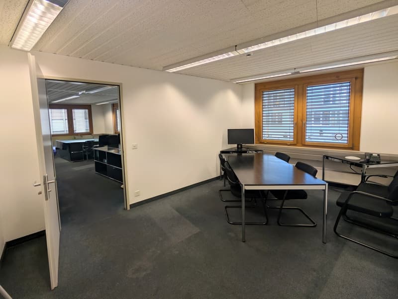 empty room, long table, chairs, computer monitor, windows, mirrors