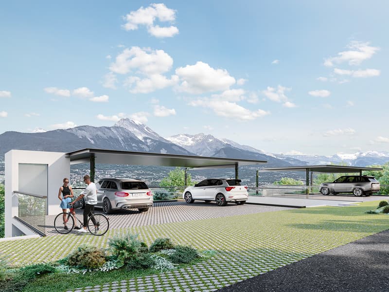 Modern house with a carport, 3 cars parked, green lawn, mountains in the background
