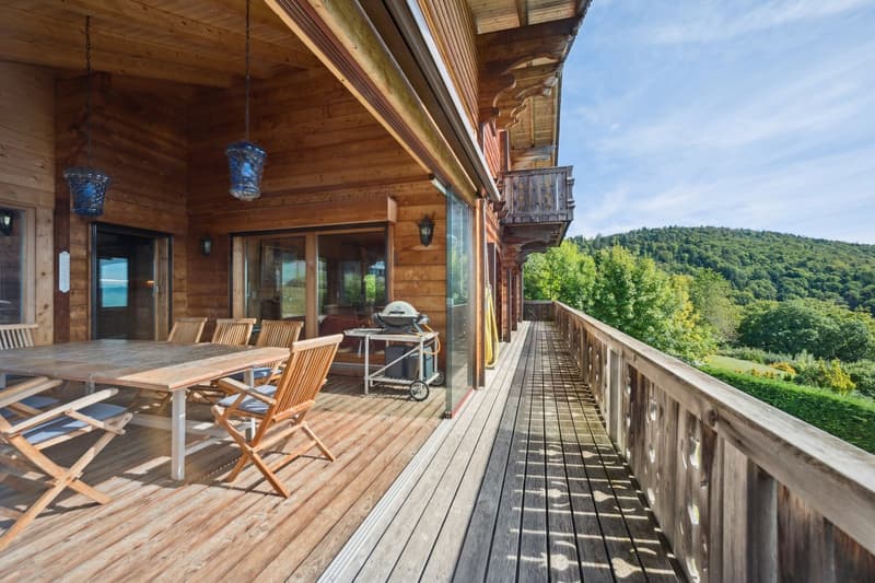 wooden deck, wooden railing, table and chairs, BBQ, lamps, view of mountains