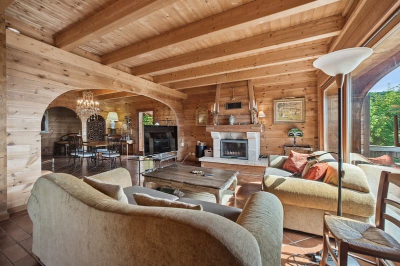 Wooden interior, sofa, coffee table, fireplace, chandelier, television, dining table with chairs